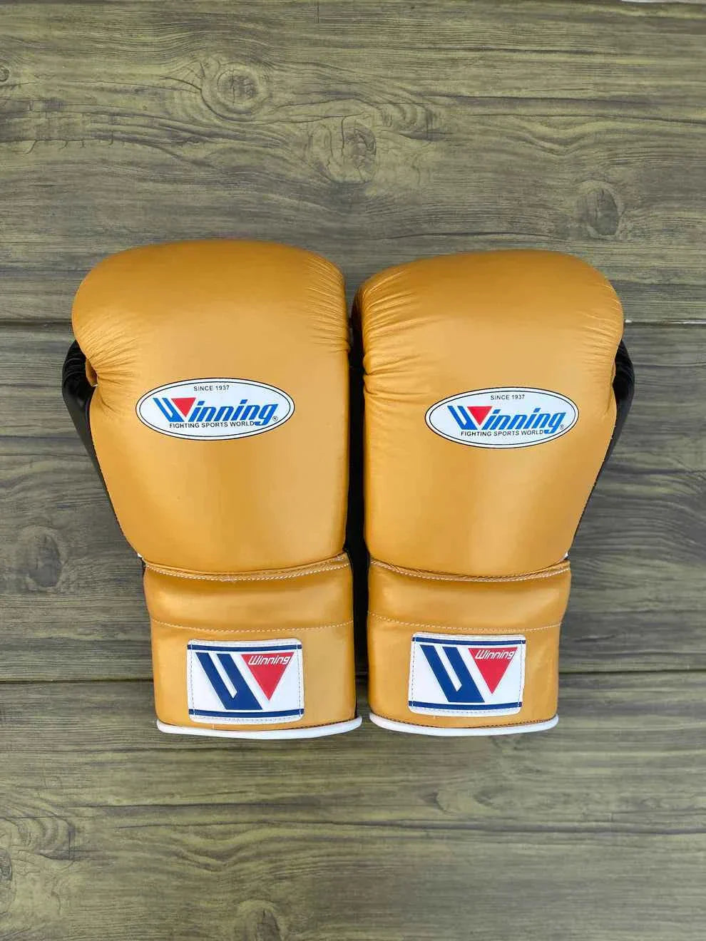 Custom Winning MS-600 professional lace-up boxing gloves in gold leather with black palms, handcrafted in Japan.