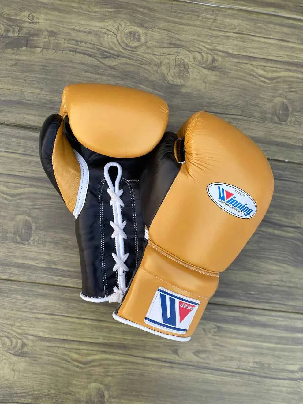 Custom Winning MS-600 professional lace-up boxing gloves in gold leather with black palms, handcrafted in Japan.