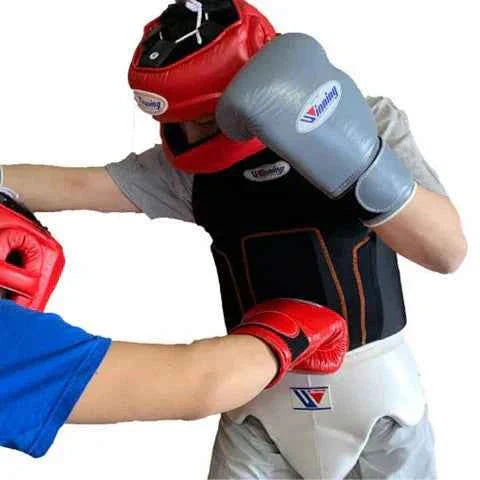 Winning BP-100 professional boxing body protector shirt in black compression fabric featuring padded abdominal and rib blocks with official branding.