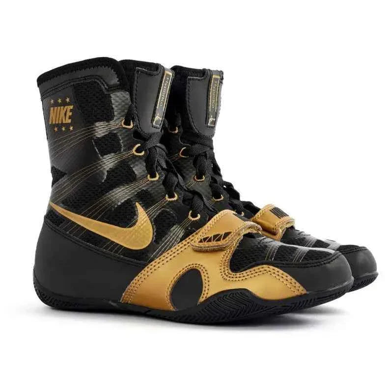 Professional Nike Hyperko 1 boxing boots in sleek black and metallic gold featuring Flywire support and a forefoot strap.