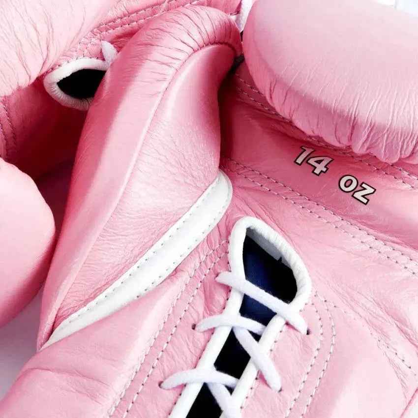 Official Winning professional lace-up training boxing gloves in premium pink leather featuring white laces, a white contrast lacing border, and the iconic brand logo crest on the cuffs.