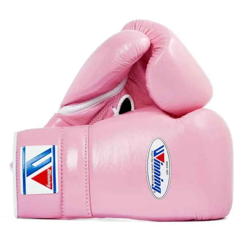 Official Winning professional lace-up training boxing gloves in premium pink leather featuring white laces, a white contrast lacing border, and the iconic brand logo crest on the cuffs.