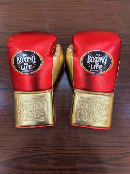 No Boxing No Life red and gold leather boxing gloves with brand logo on wooden surface