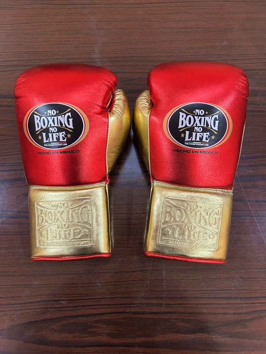 No Boxing No Life red and gold leather boxing gloves with brand logo on wooden surface
