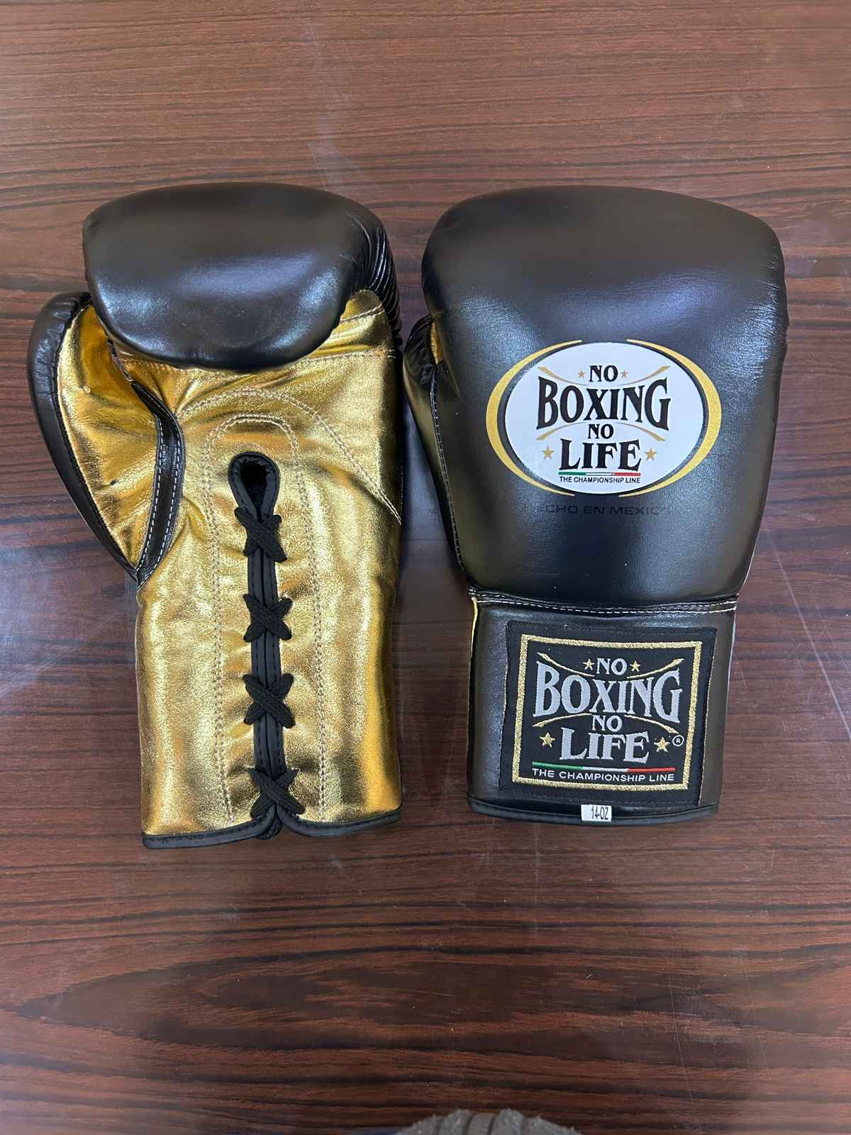 Authentic black and gold No Boxing No Life professional boxing gloves handcrafted in Mexico with official branding.