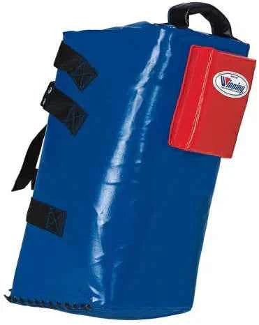 Winning BC-4500 professional boxing combination bag shield in royal blue featuring a red target block with official branding, a heavy-duty top handle, and reinforced side strap handles.