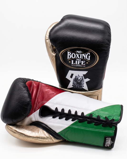 Matte black boxing glove with metallic gold cuff side view
