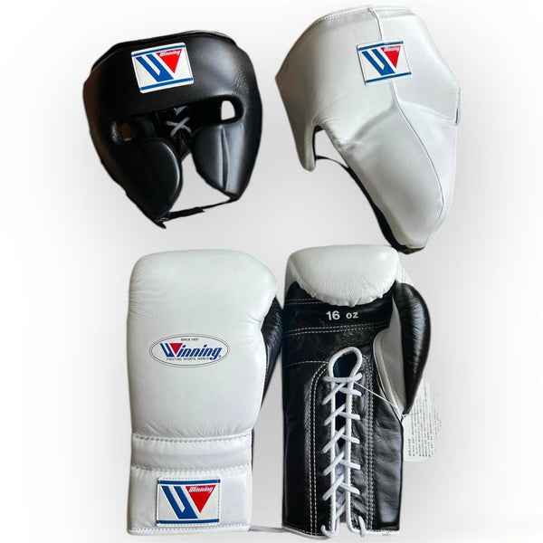 Custom Winning professional 3-piece boxing sparring gear set featuring black and white leather dual-tone lace-up gloves, a black face guard headgear, and a white groin protector over a white background.