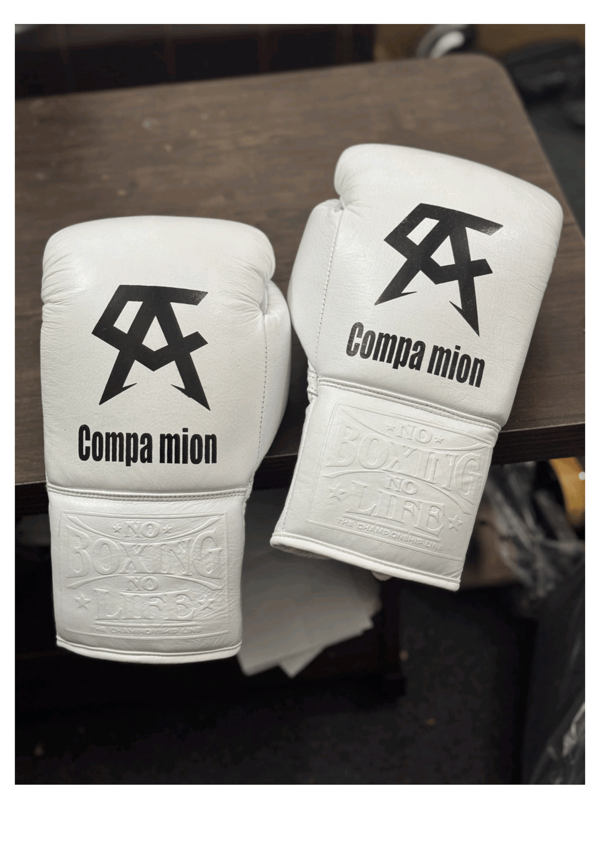 Official No Boxing No Life professional lace-up boxing gloves in pristine white leather featuring a black Canelo Alvarez CA logo and custom Companion text graphic printed on the knuckles.