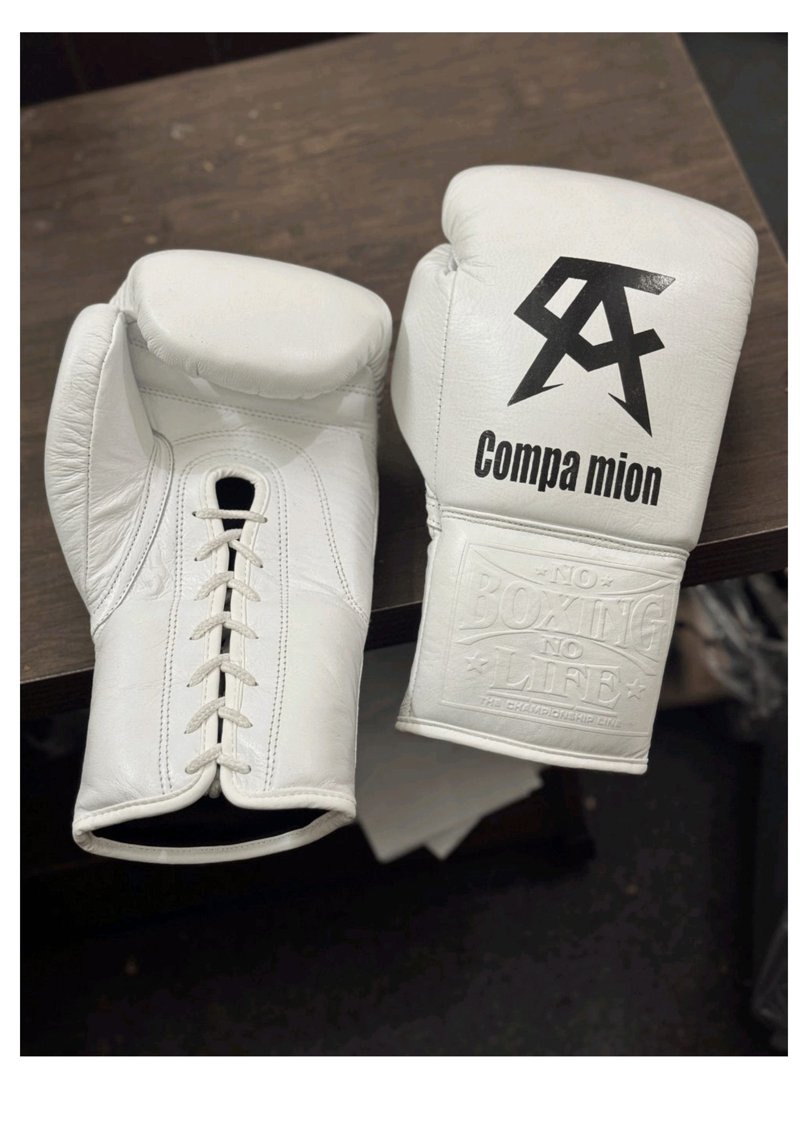 Official No Boxing No Life professional lace-up boxing gloves in pristine white leather featuring a black Canelo Alvarez CA logo and custom Companion text graphic printed on the knuckles.