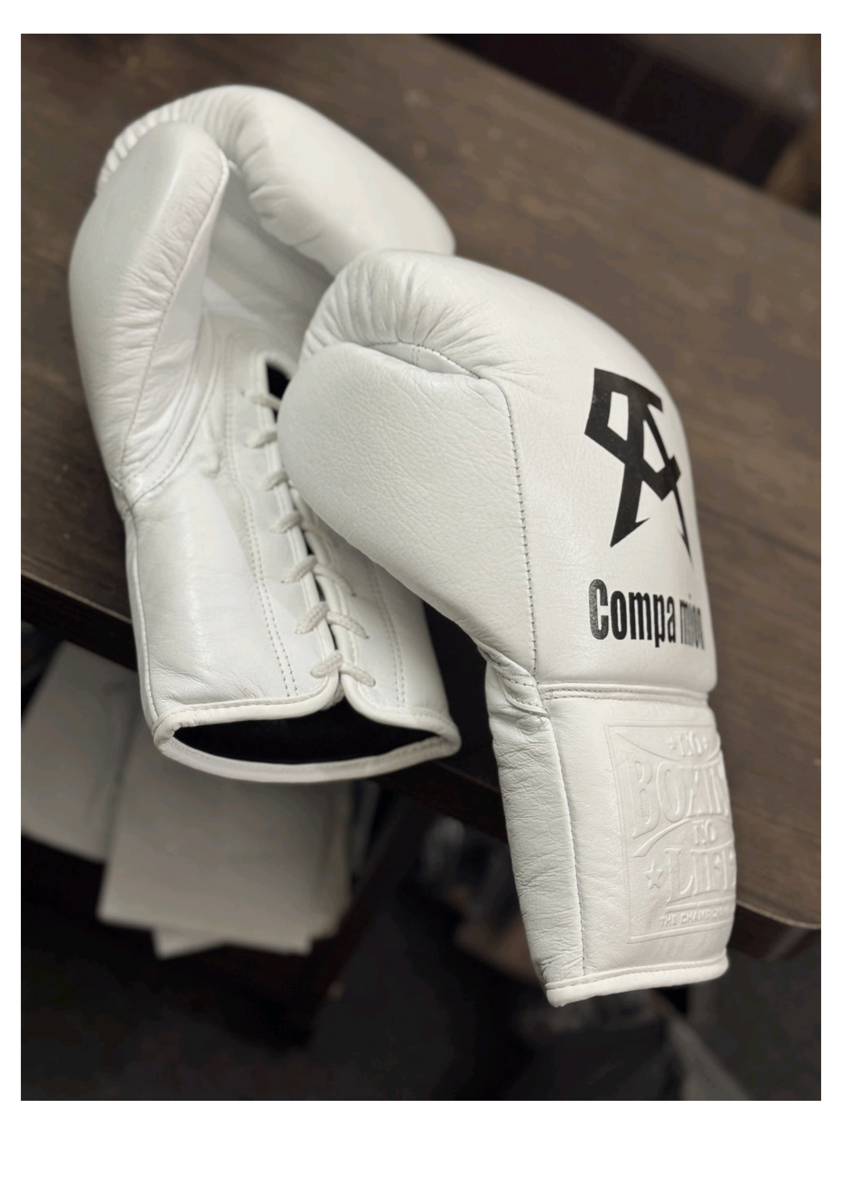 Official No Boxing No Life professional lace-up boxing gloves in pristine white leather featuring a black Canelo Alvarez CA logo and custom Companion text graphic printed on the knuckles.