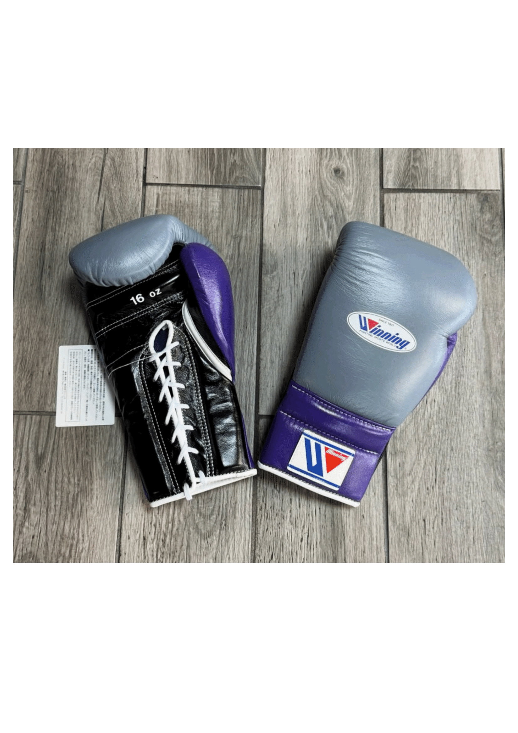Custom Winning professional lace-up training boxing gloves in metallic gray and purple premium leather, featuring white lacing, white edge piping, and the iconic brand logo crest on the cuff.