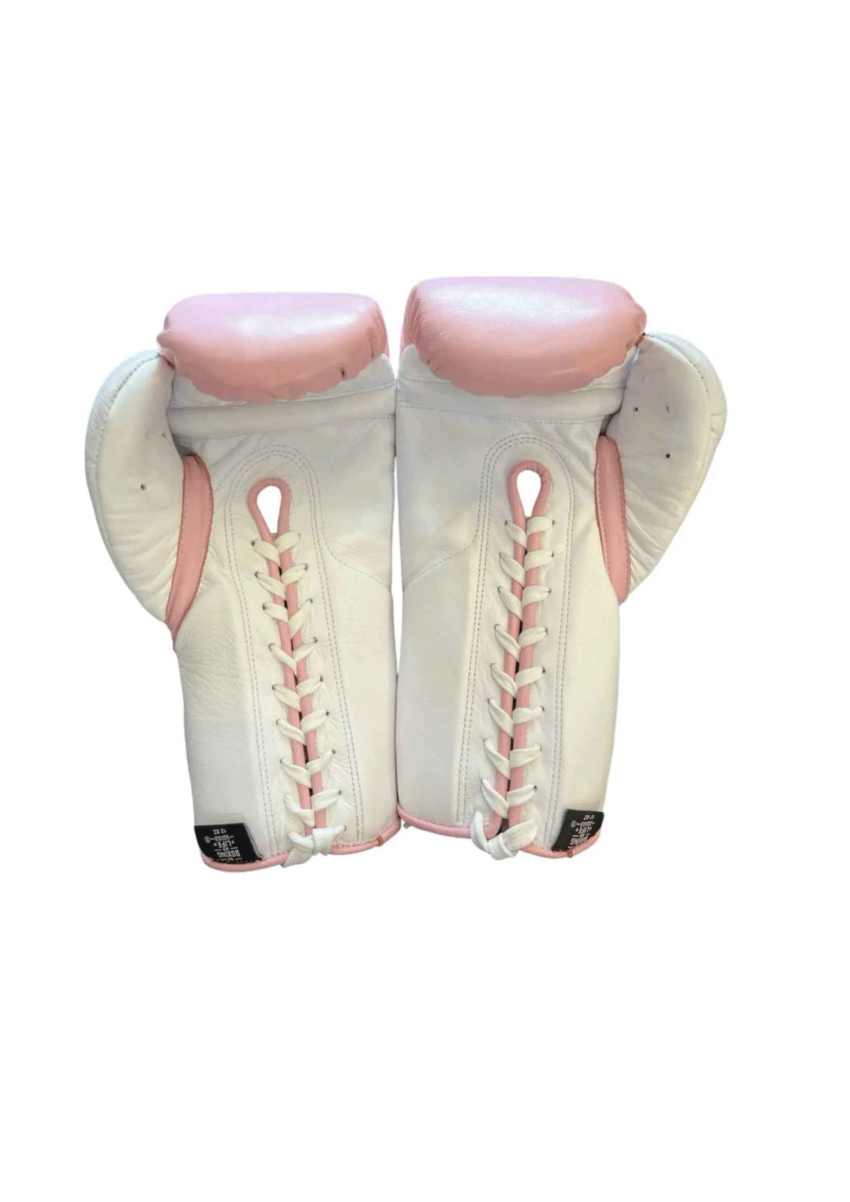 Official No Boxing No Life professional lace-up training boxing gloves in pink leather featuring white cuffs, white lacing panels, a white inner palm track, and the iconic oval brand logo on the knuckles.