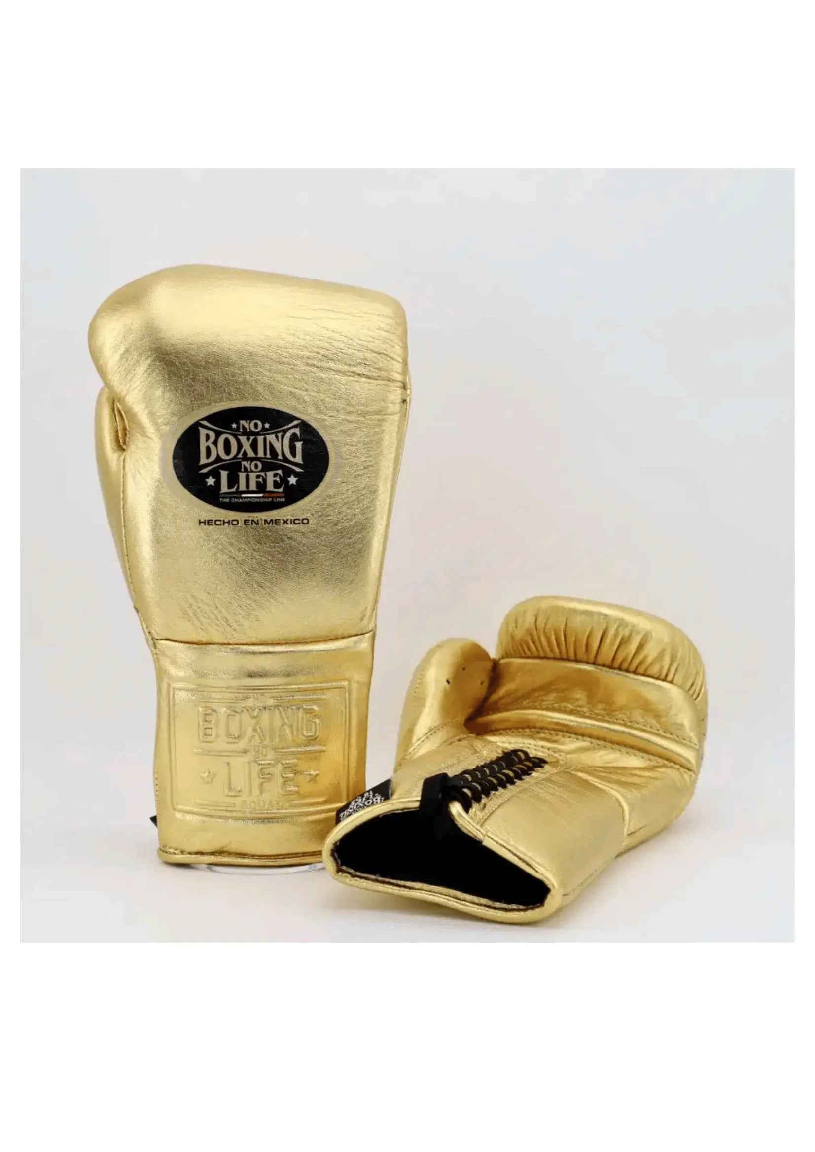 Official No Boxing No Life professional lace-up boxing gloves in metallic gold leather showing the iconic black oval brand logo patch on the knuckles and an embossed logo on the cuff.