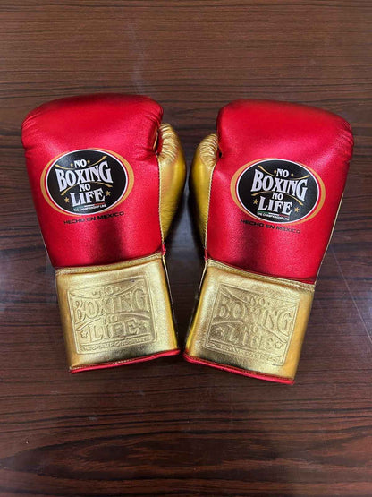 Close-up of metallic red and gold leather glove finish