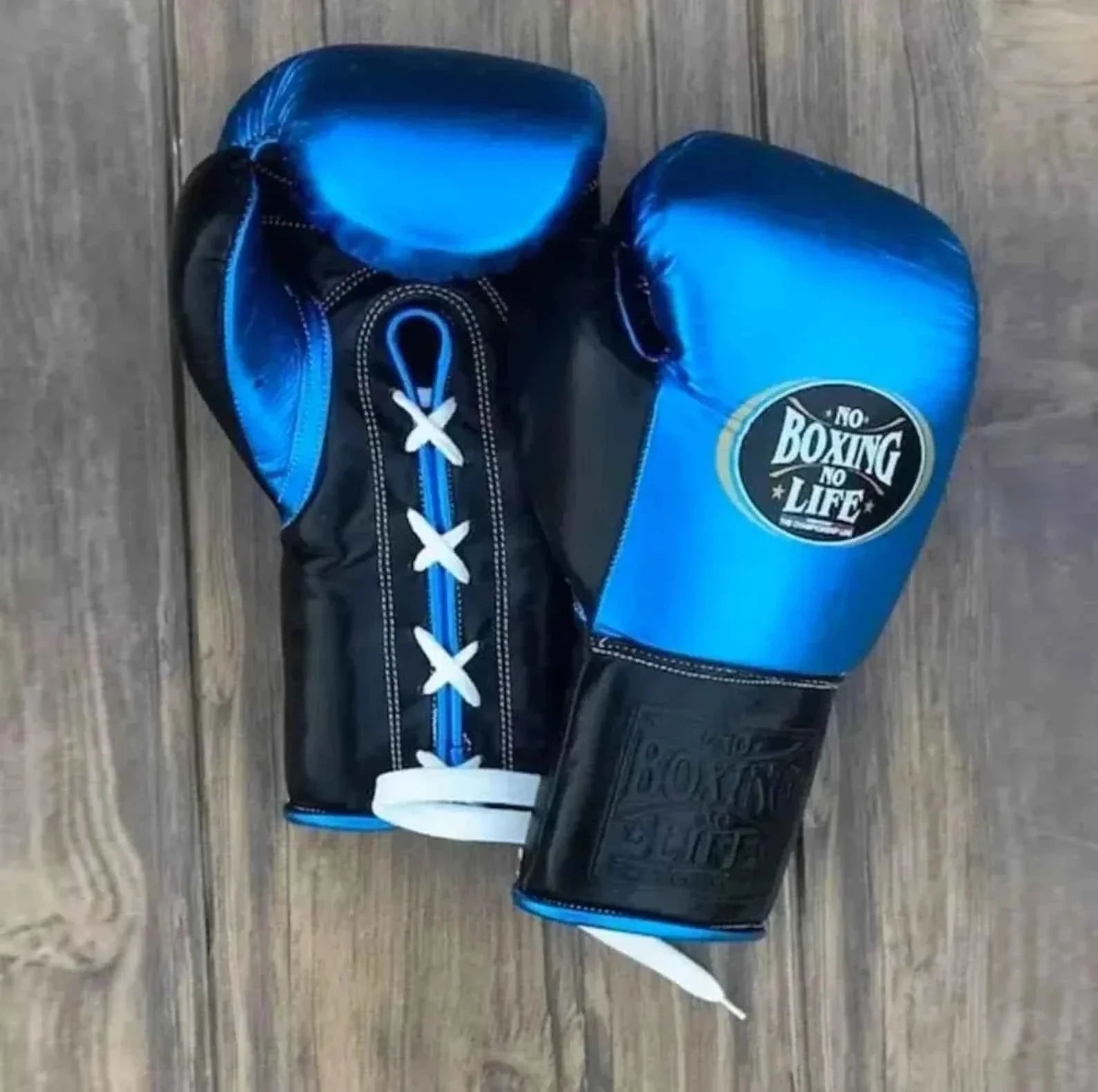 No Boxing No Life custom professional lace-up boxing gloves in metallic blue leather with black palms and cuffs.