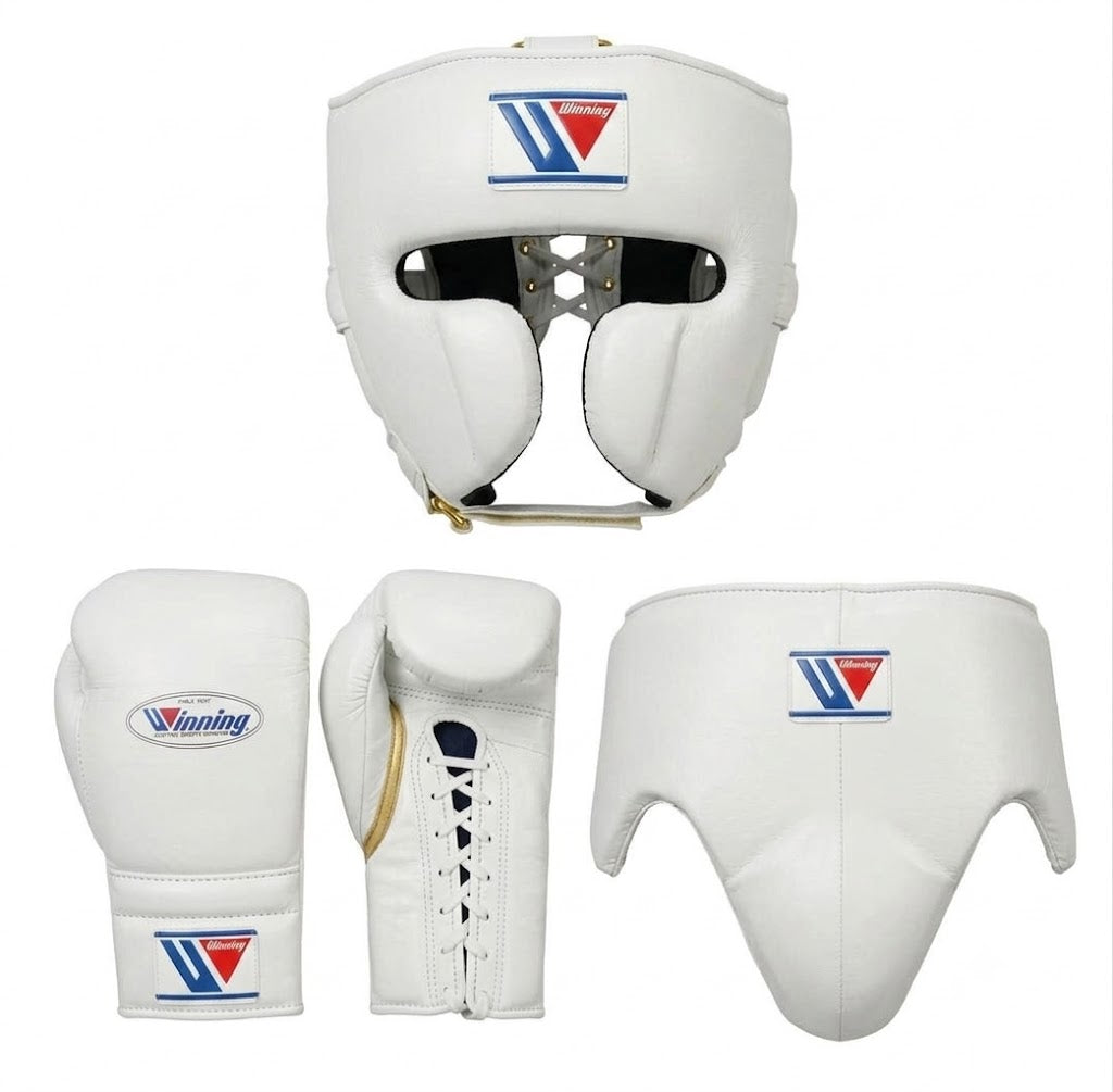 White boxing protective gear set including a headguard, boxing gloves, and a chest protector, shown from multiple angles on a white background. The gear features a blue and red triangular logo with the brand name 'Vueling'.